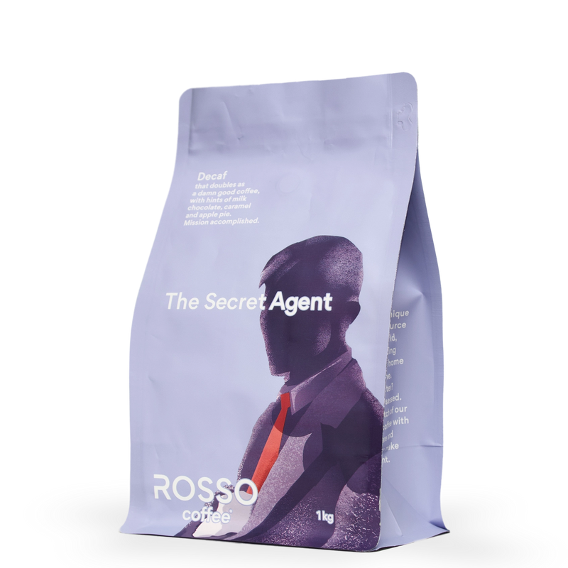 A 1kg bag of Rosso Coffee Secret Agent Decaf Specialty Coffee blend, tasting notes include soft body and a nutty caramel finish